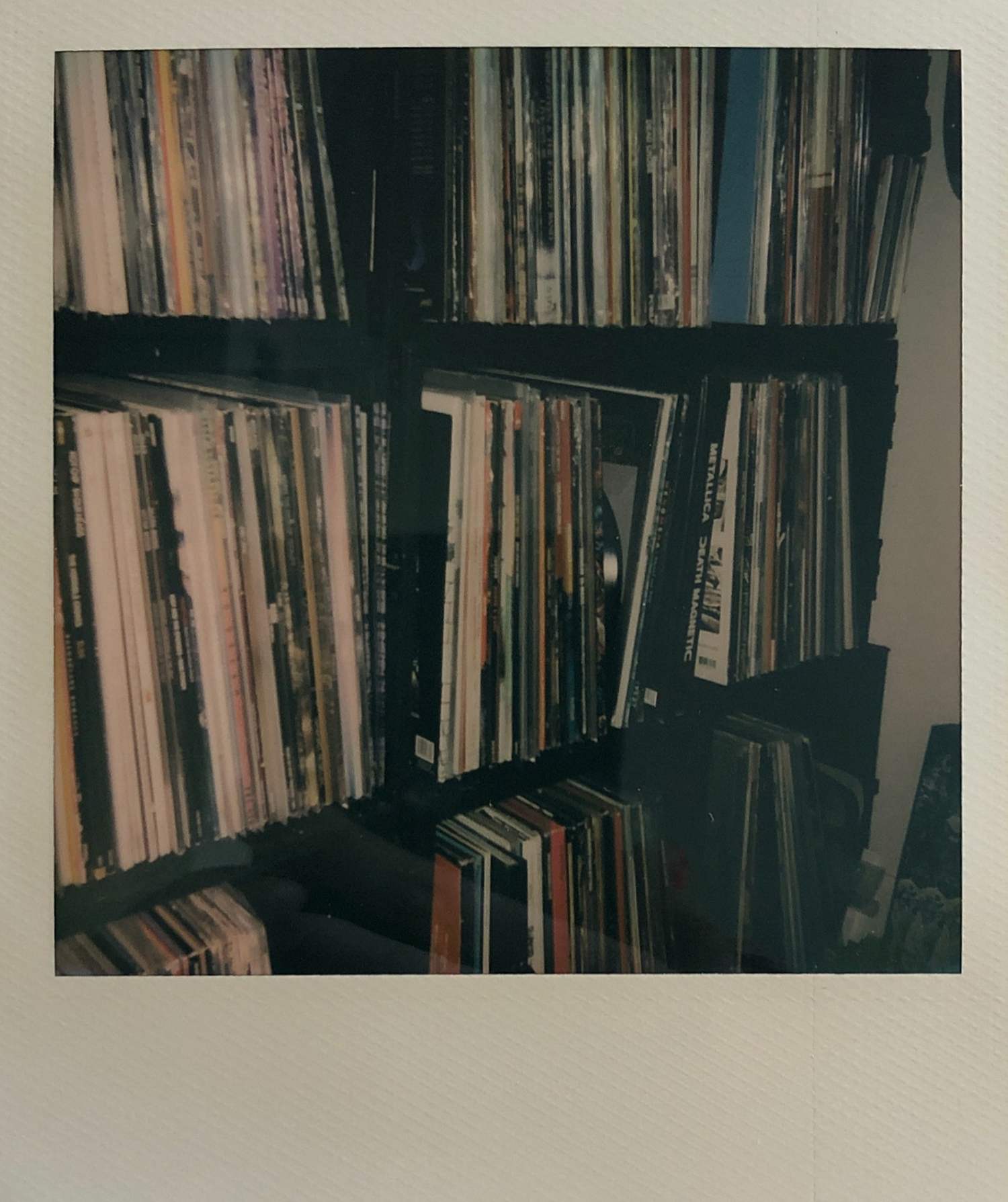 A Polaroid photo of my record collection in the 9 travel cases I store them