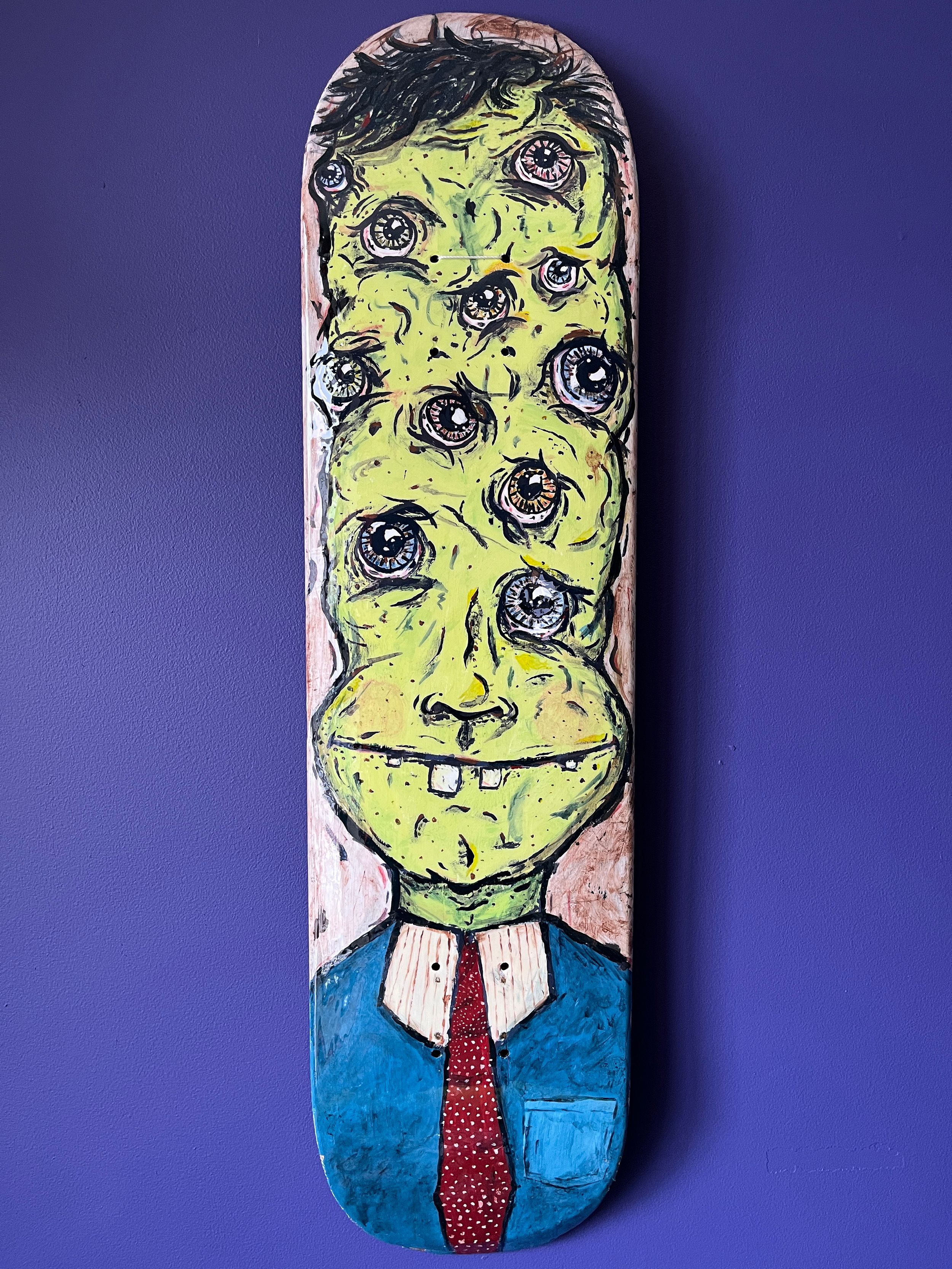 A painting of a human-looking, green-skinned being with 11 eyes, buck teeth. The painting is on a skateboard deck, so the character's head is elongated. He's wearing a blue dress shirt with a white collar and a red tie with white dots.